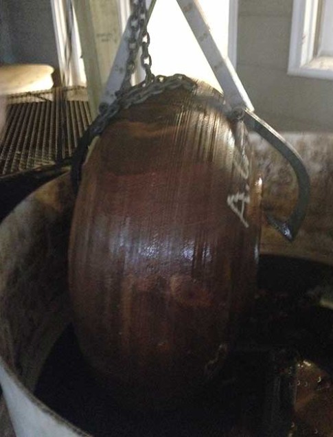 The Moulthrop family’s woodturning process involves a treatment to prevent the wood from cracking. Here, the Auburn Oak bowl is being removed from treatment.