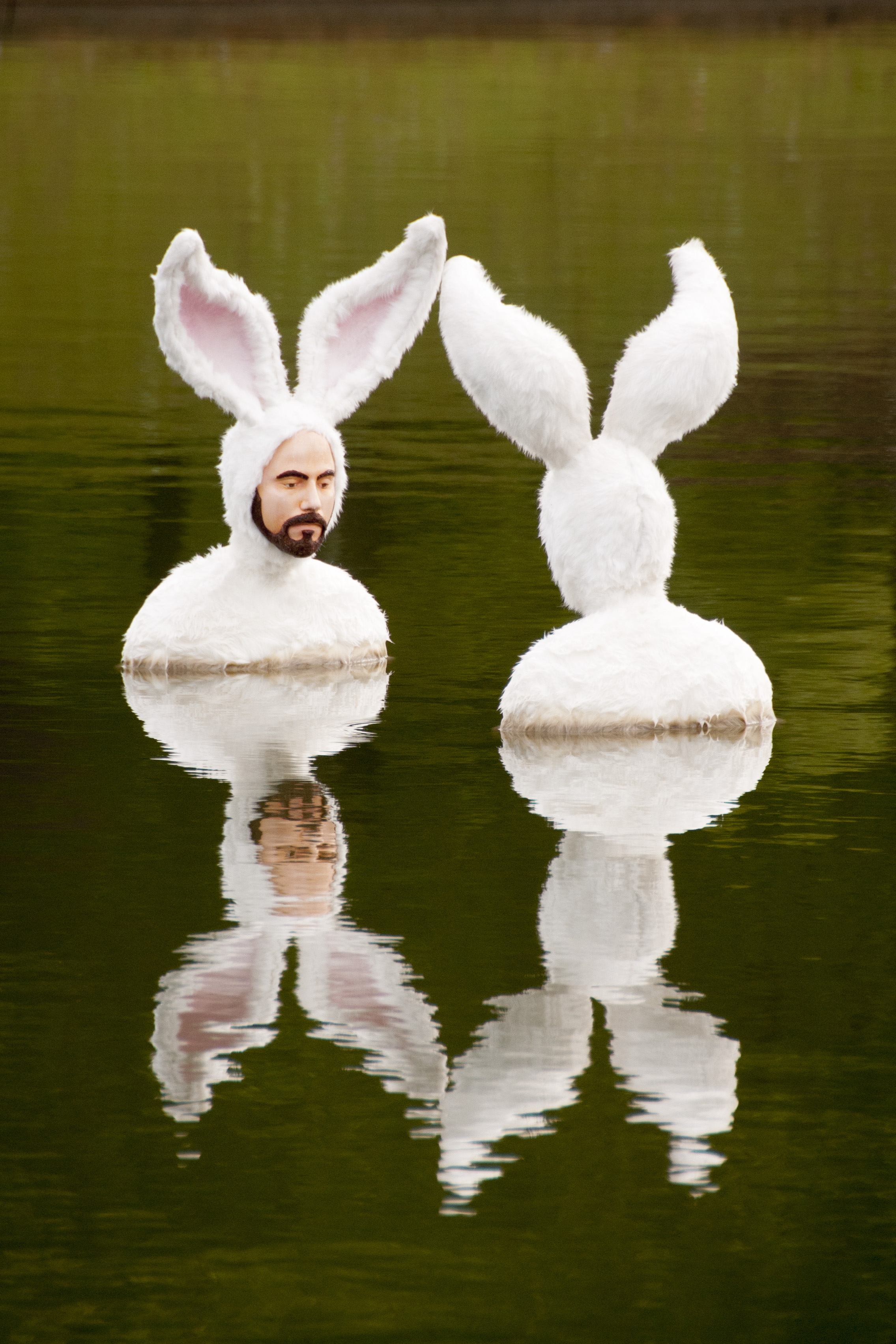A water feature sculpture of two men in bunny suits