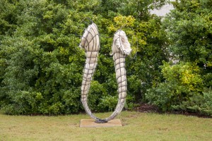 Horseshoe-shaped sculpture made from artificial human hair and steel