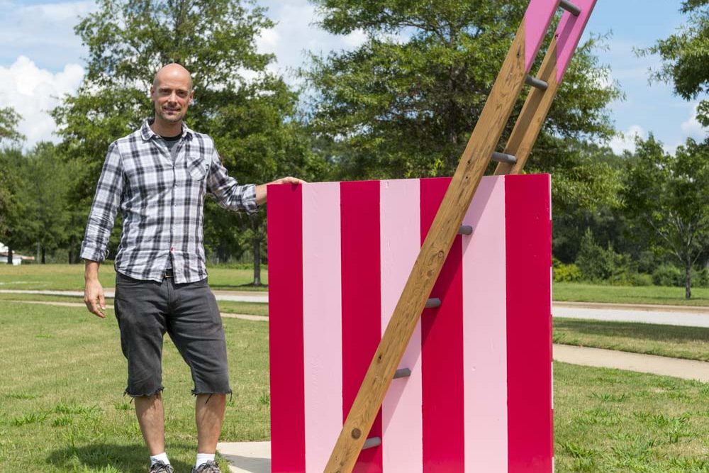 Steve Rossi of New York poses with his work, Reciprocal Ladder to Intersect, 2016