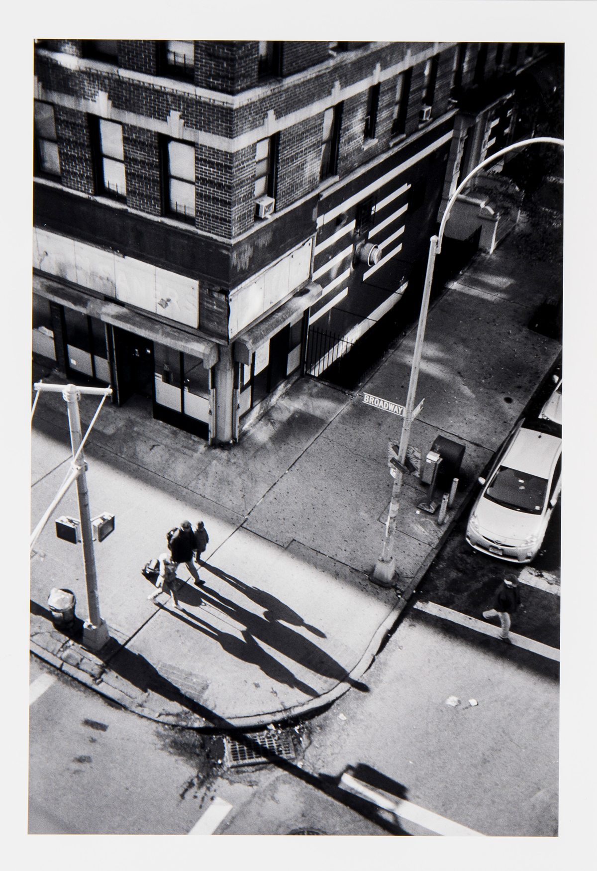 A photograph of passersby on the street from a high vantage