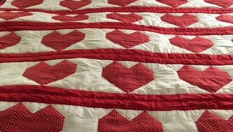 A handmade quilt with heart design