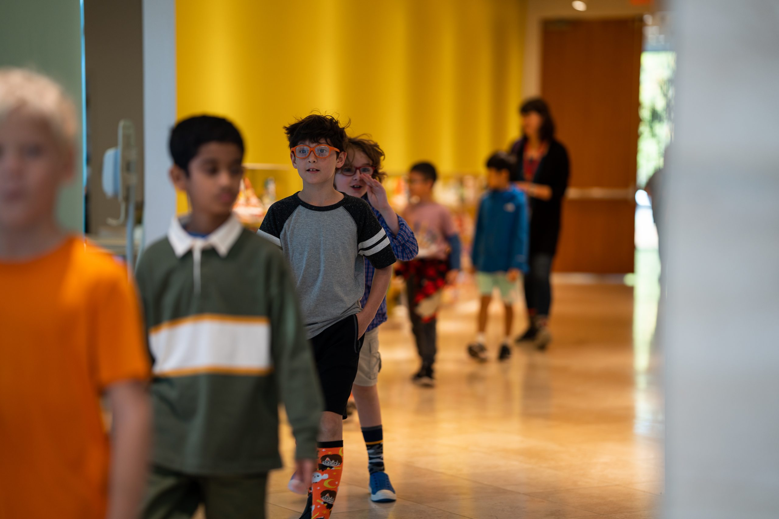A line of students walk through the galleries.