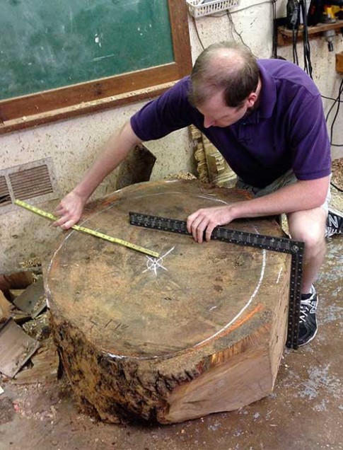 Third generation woodturner Matt Moulthrop of Atlanta measures a section of the College Street oak.