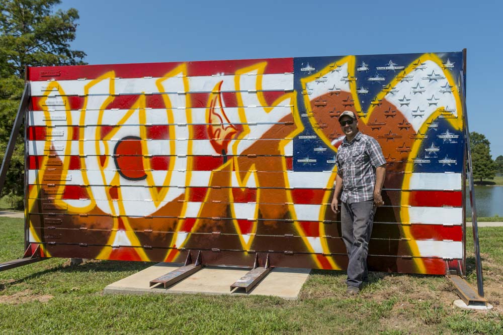 Alabama artist Ira Hill poses with his work, American Expressions