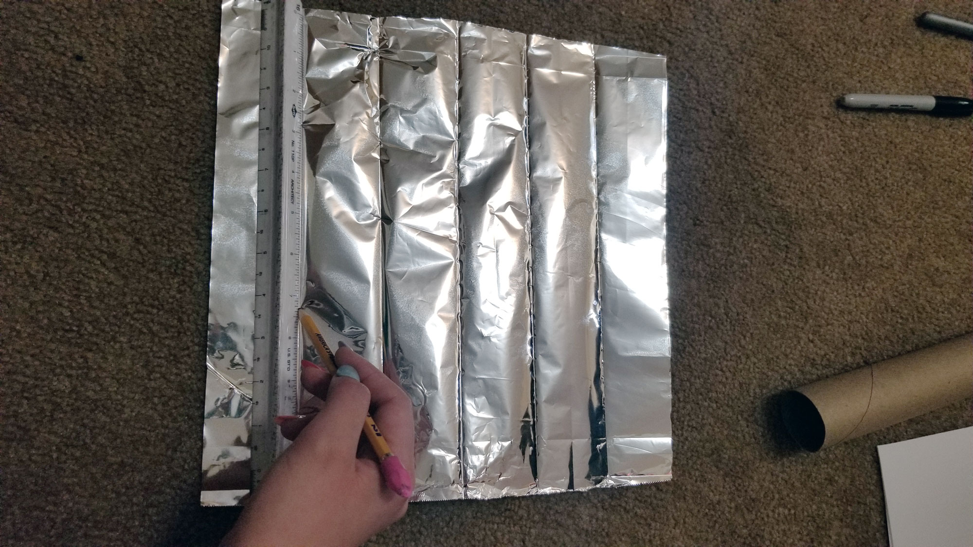 Mark off sections of aluminum foil with a pencil.