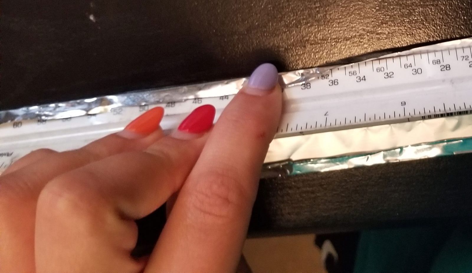 Aluminum foil wrapped around a ruler to give it a rectangular shape.