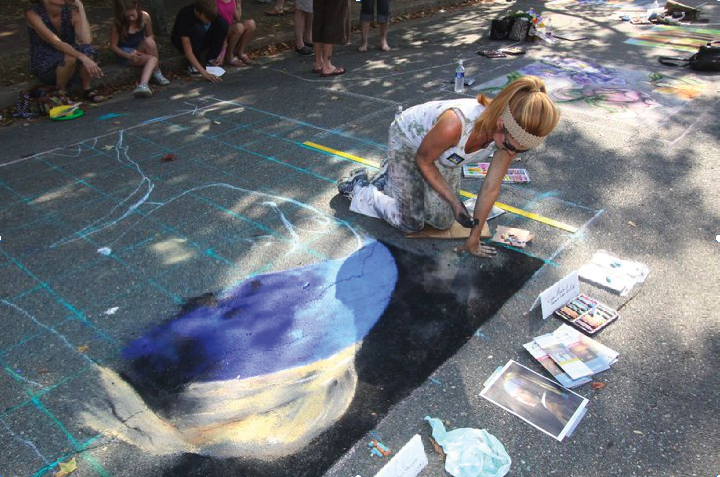 An artist recreates a painting on the street