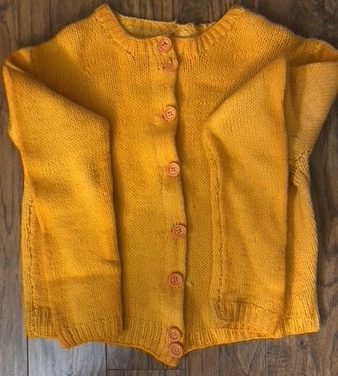 A soft handmade sweater in a warm and cheery yellow.
