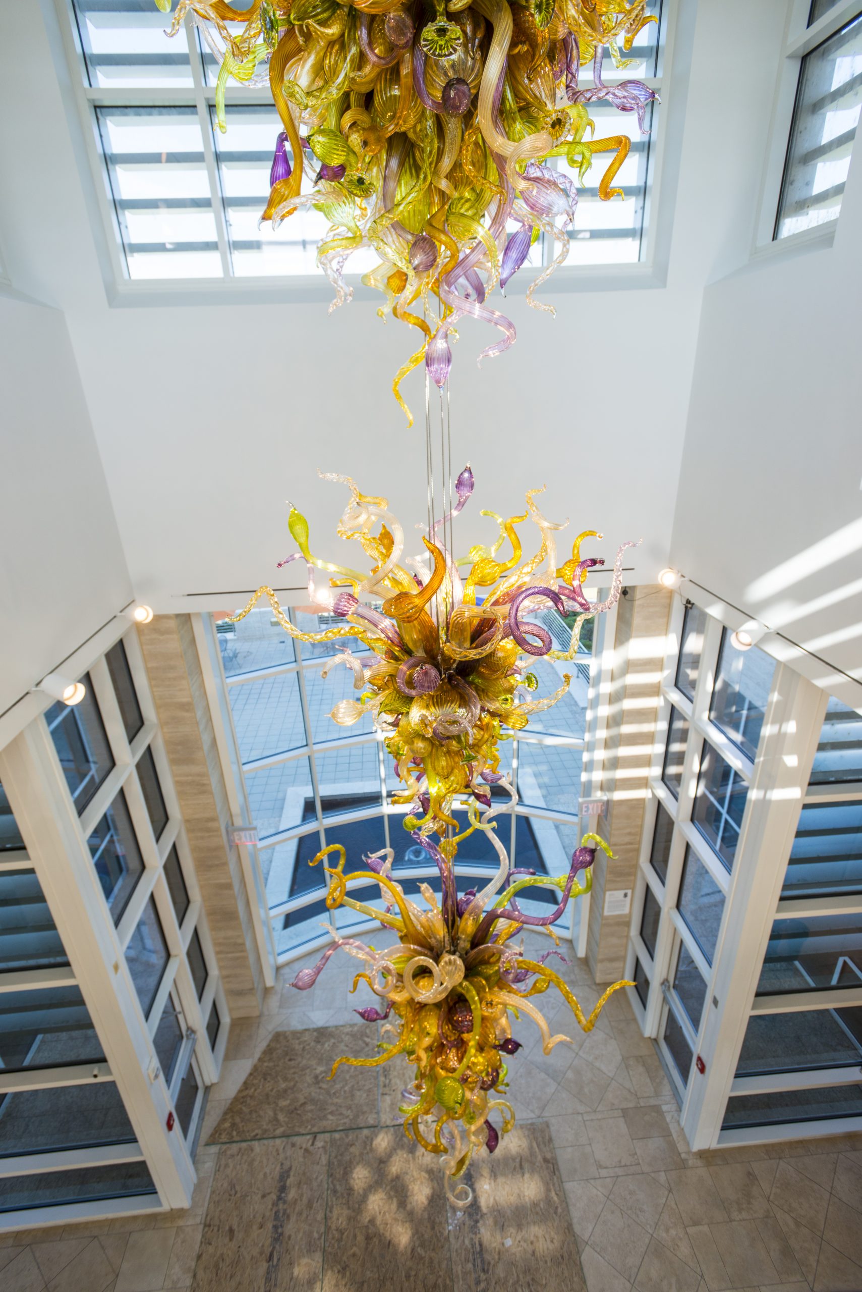 An intricate glass sculpture hangs from the ceiling.