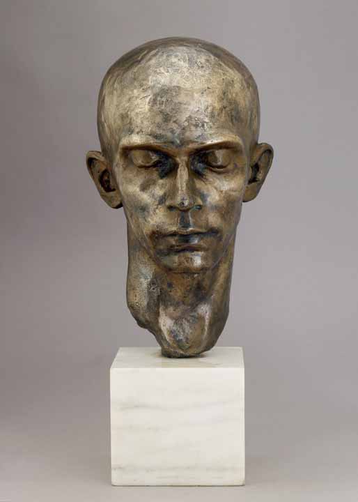 A bronze sculpture of bald person with eyes closed
