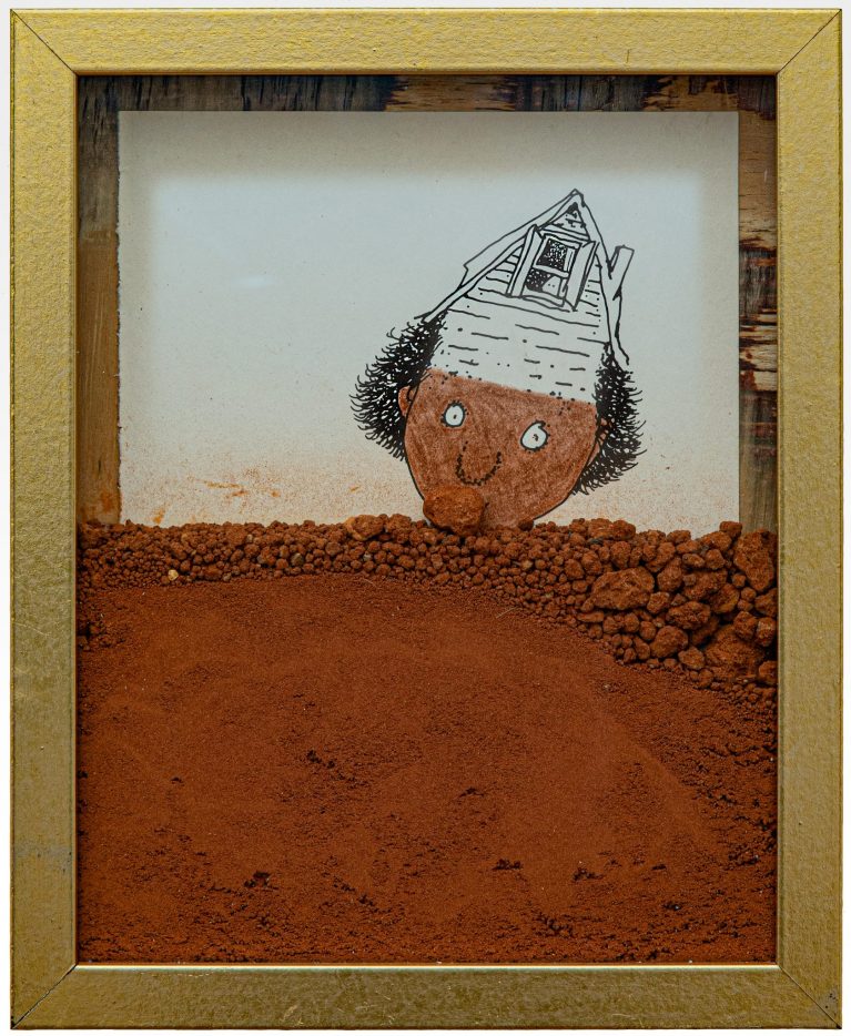 Dirt and pebbles partially cover an illustration of a person whose head is part of a house.