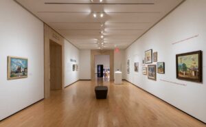 Paintings, sculpture and photographs displayed in a gallery