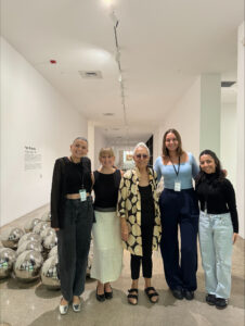 Photo of Kate Hoppe with Rubell Museum interns and museum founder Mara Rubell.