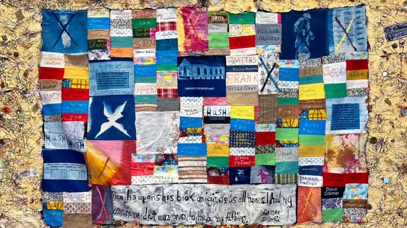 Photo of quilt made with a variety of fabrics and colors with pieces that include names such as Sarah, Harry, and Joe. At the bottom center, a larger white fabric piece features text: "Den he opens his book an gives us all names. I had my own name dat wuz give to me by my father. Former slave." Quilt made by Wini McQueen.