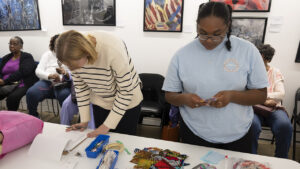 Two students select quilting materials at a public quilting session