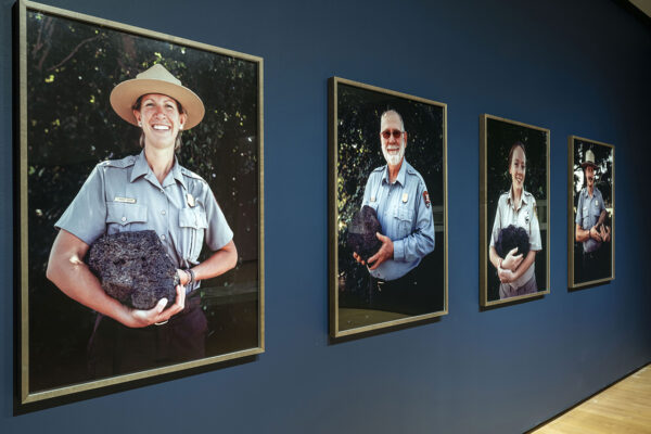 Large scale portraits of U.S. National Park Rangers in uniform, holding their favorite rocks, from the exhibition, "Binh. Danh: Advancing American Art."