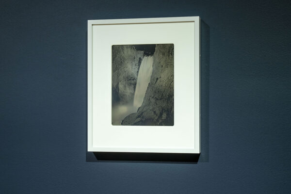 A closeup of a daguerreotype from the exhibition, "Binh Danh: Advancing American Art." The photograph shows a waterfall between two cliffs of high rock.