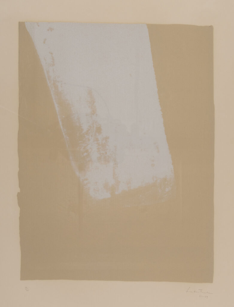 Mottled, white rectangle hanging down diagonally from the top on a pale tan background.