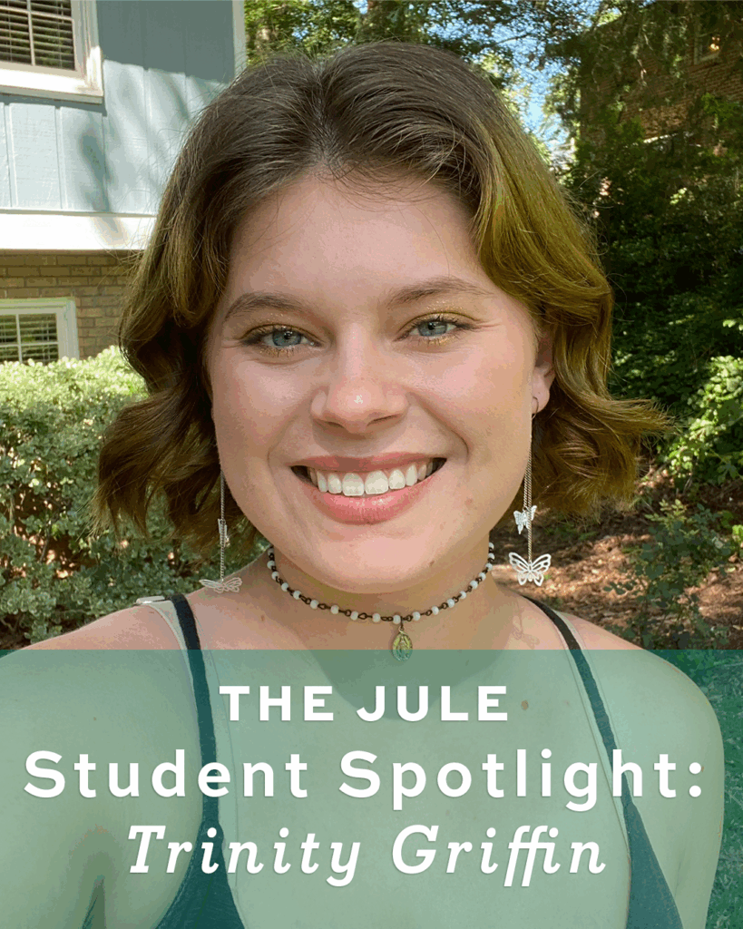 Selfie of Trinity Griffin with text overlaid that reads "The Jule Student Spotlight: Trinity Griffin." She has chin length brown hair and is wearing a black camisole and choker necklace