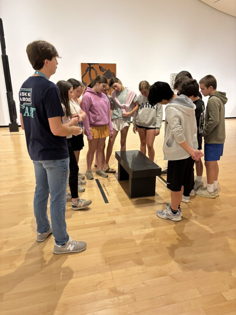 A student guide leads seventh graders on a tour of The Jule's exhibitions.